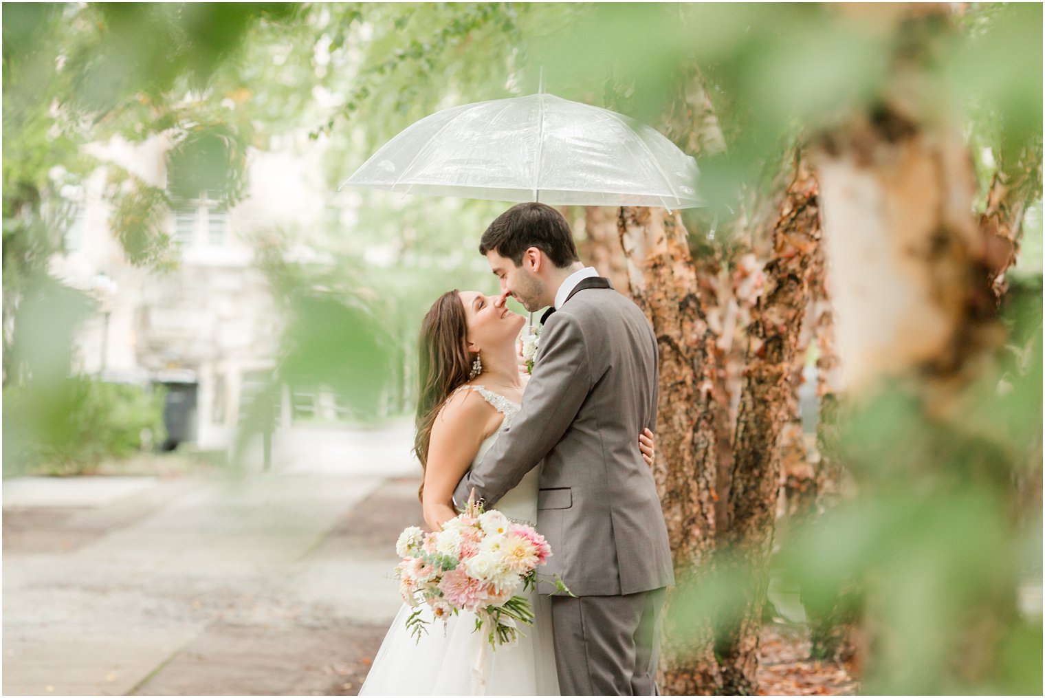 bride and groom pose under umbrella at Princeton University