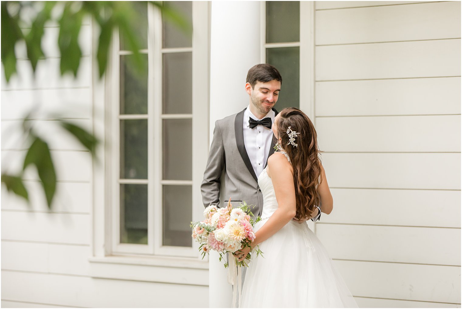 groom looks down at bride during Princeton University wedding portraits 