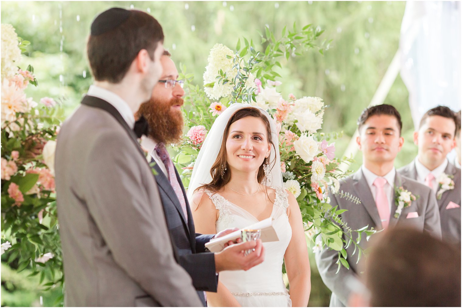 bride looks at groom during Jewish wedding ceremony