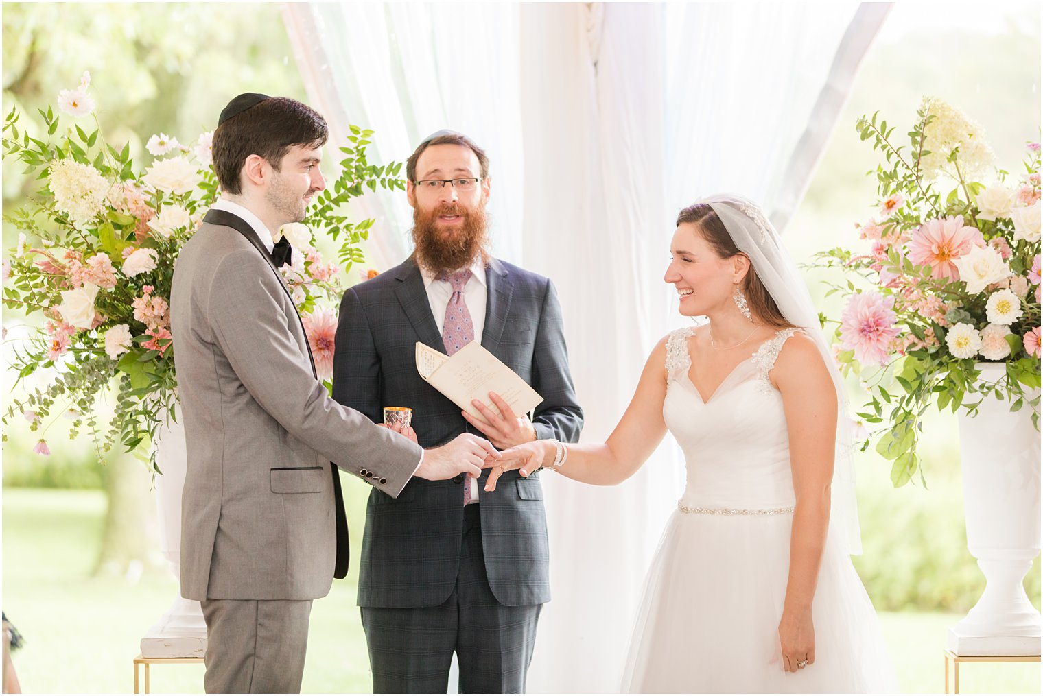 groom gives bride ring during Chauncey Hotel wedding ceremony