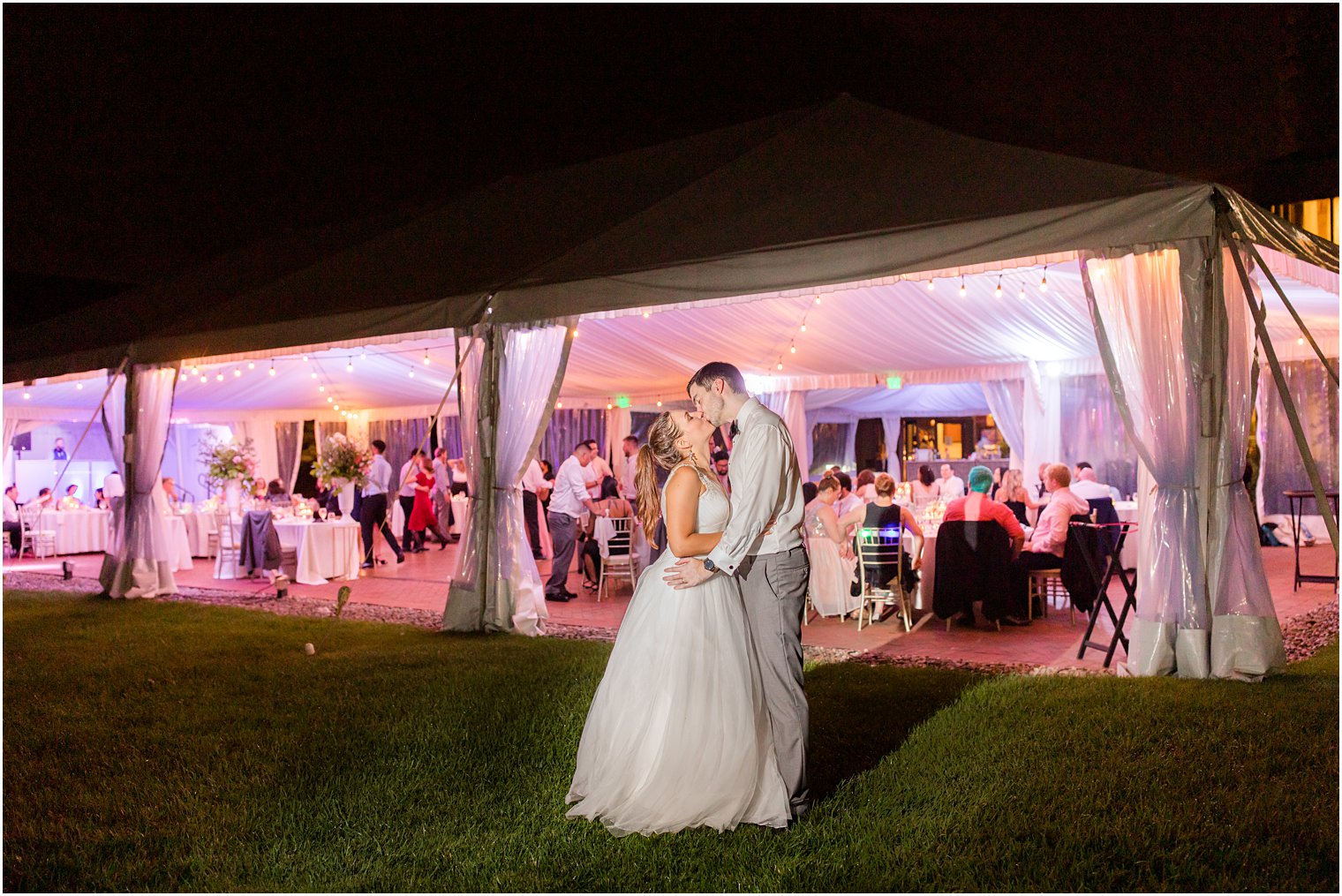 bride and groom kiss outside tent at Chauncey Hotel