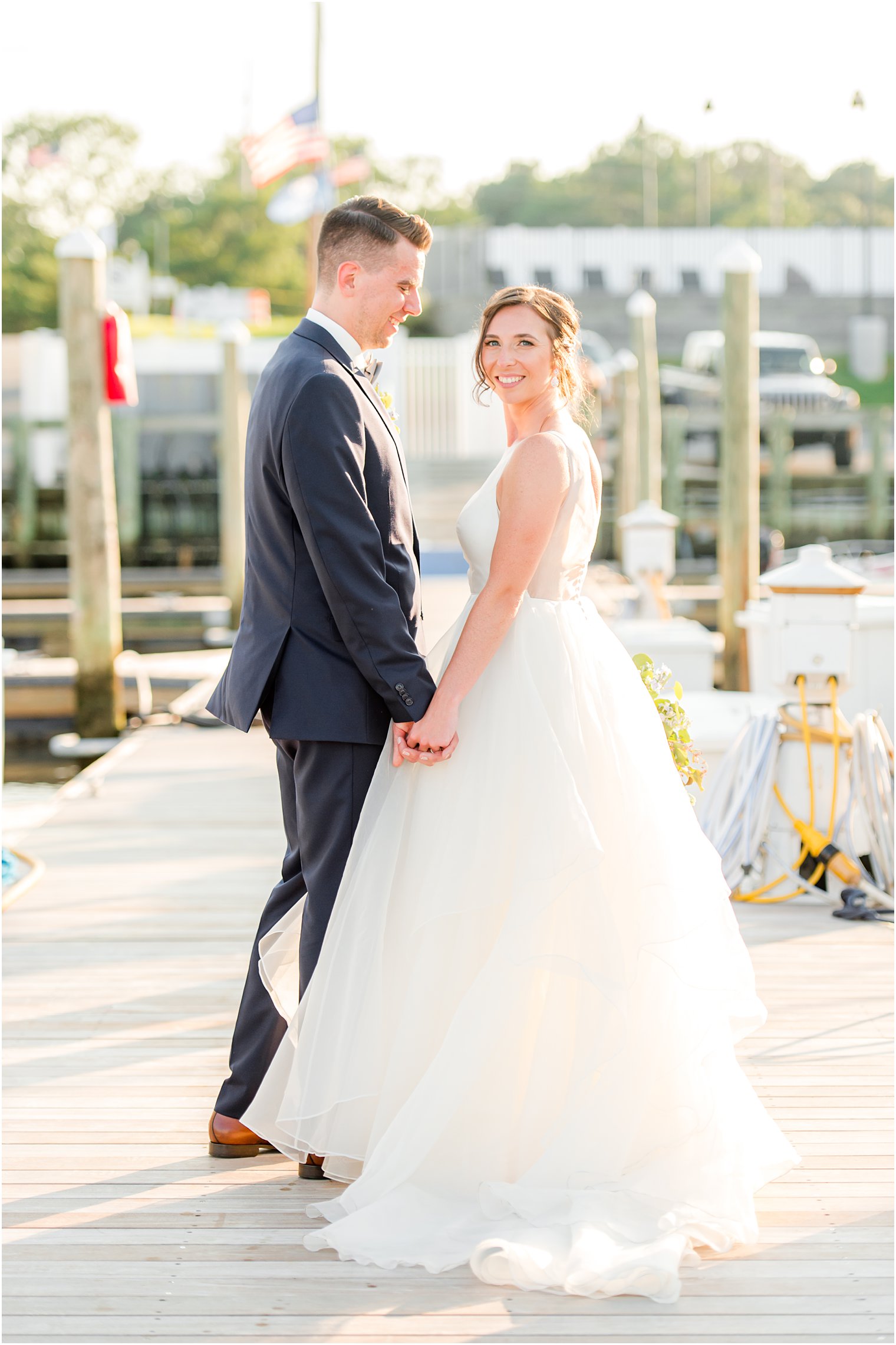 Crystal Point Yacht Club wedding portraits of bride and groom on the dock