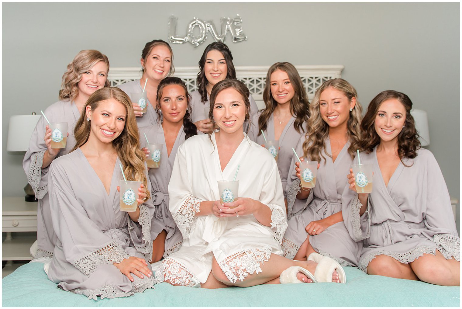 bride and bridesmaids pose with custom cups before Point Pleasant NJ wedding