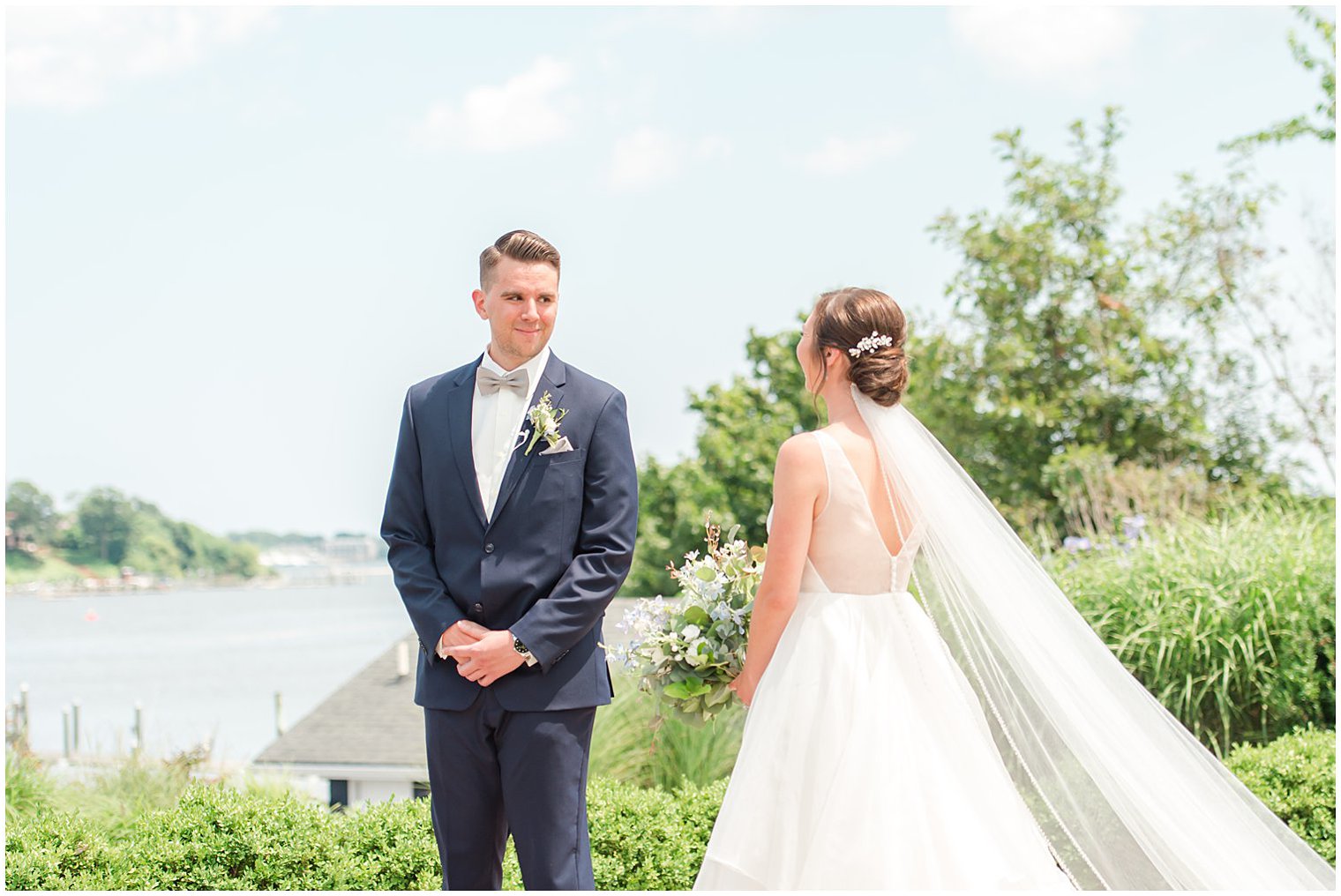 groom smiles during first look with bride on wedding day