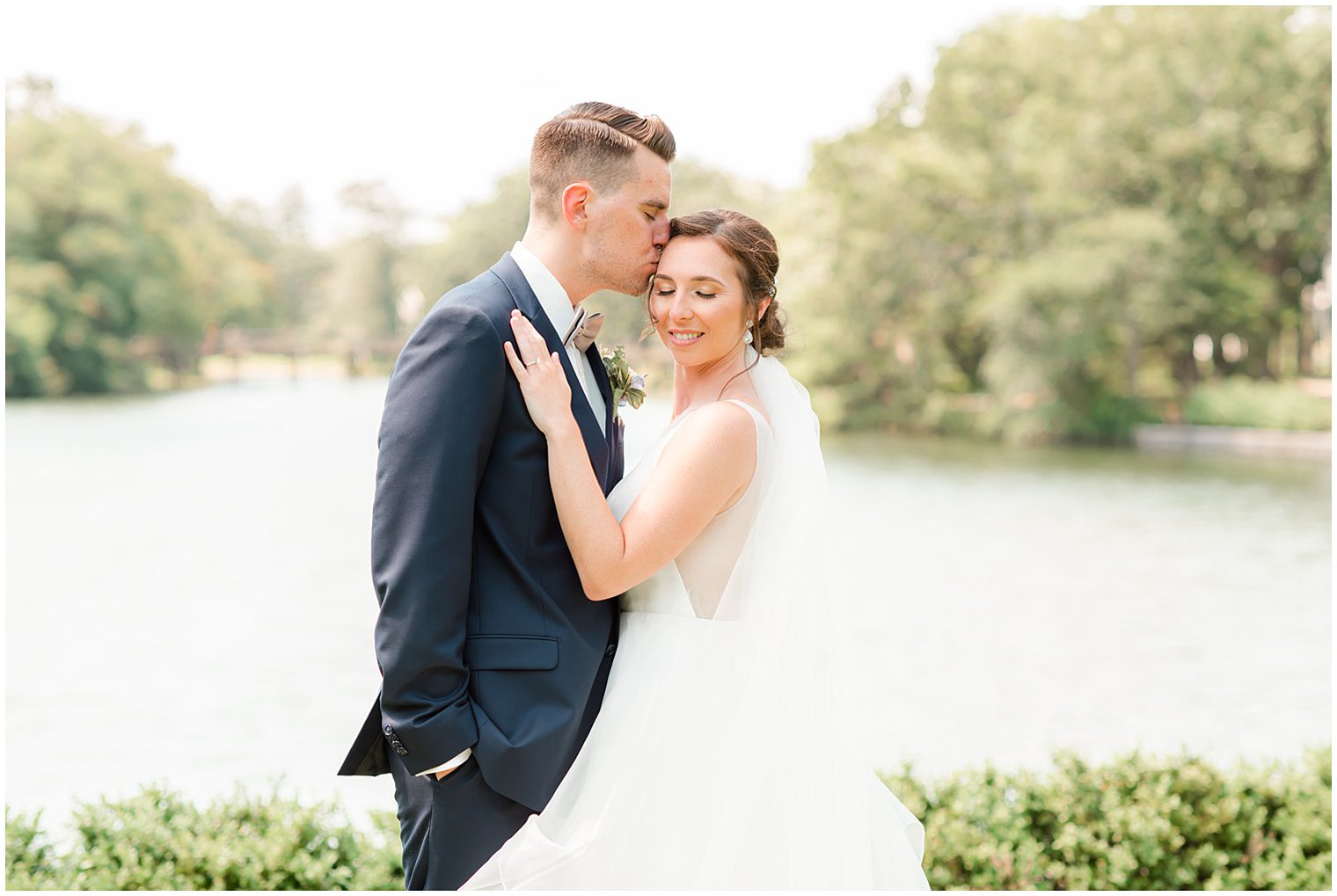 groom kisses bride's forhead during NJ wedding photos