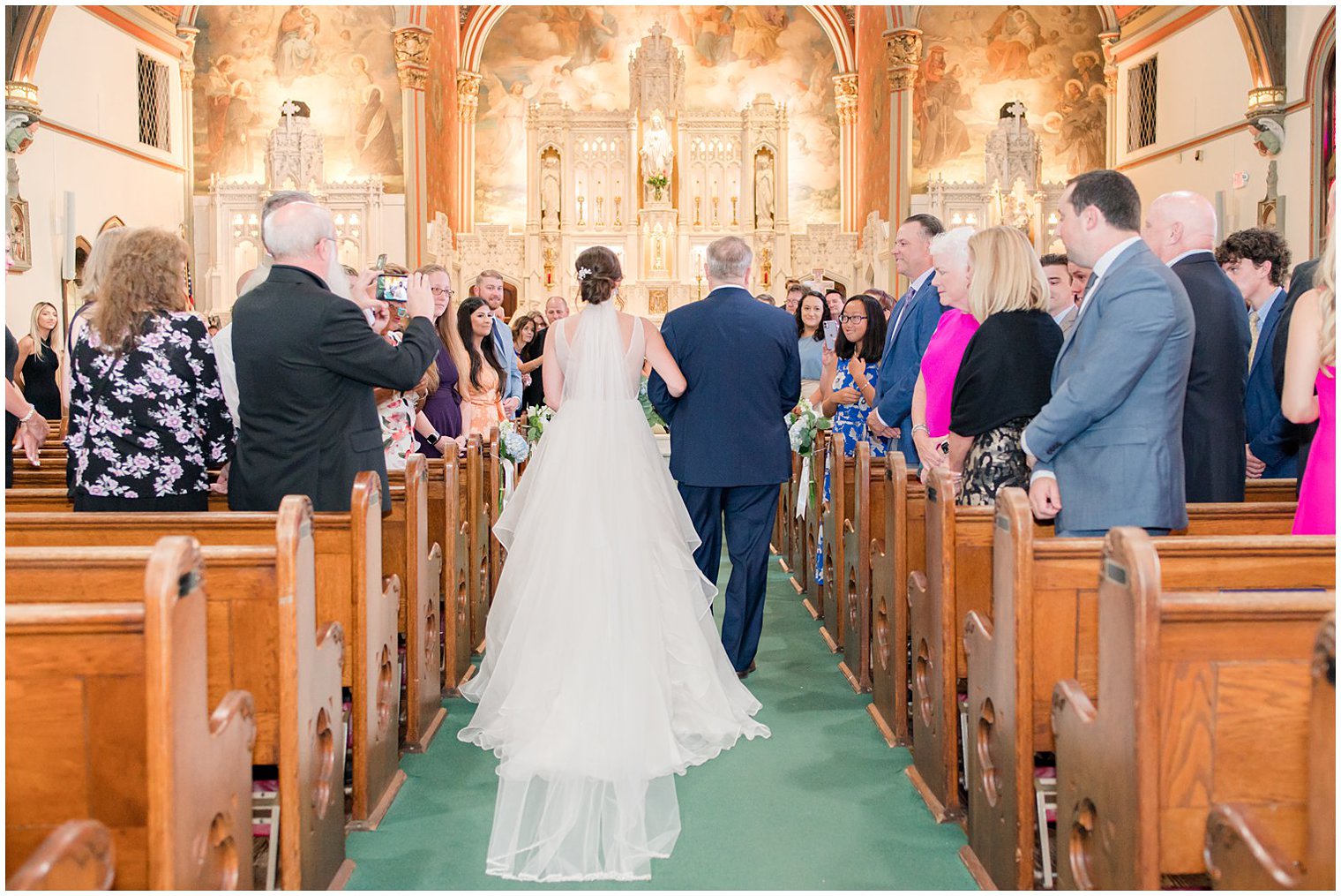 bride walks down aisle with dad before traditional church wedding in NJ