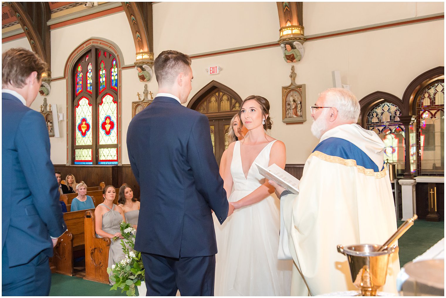 bride and groom exchange vows during traditional church wedding in NJ