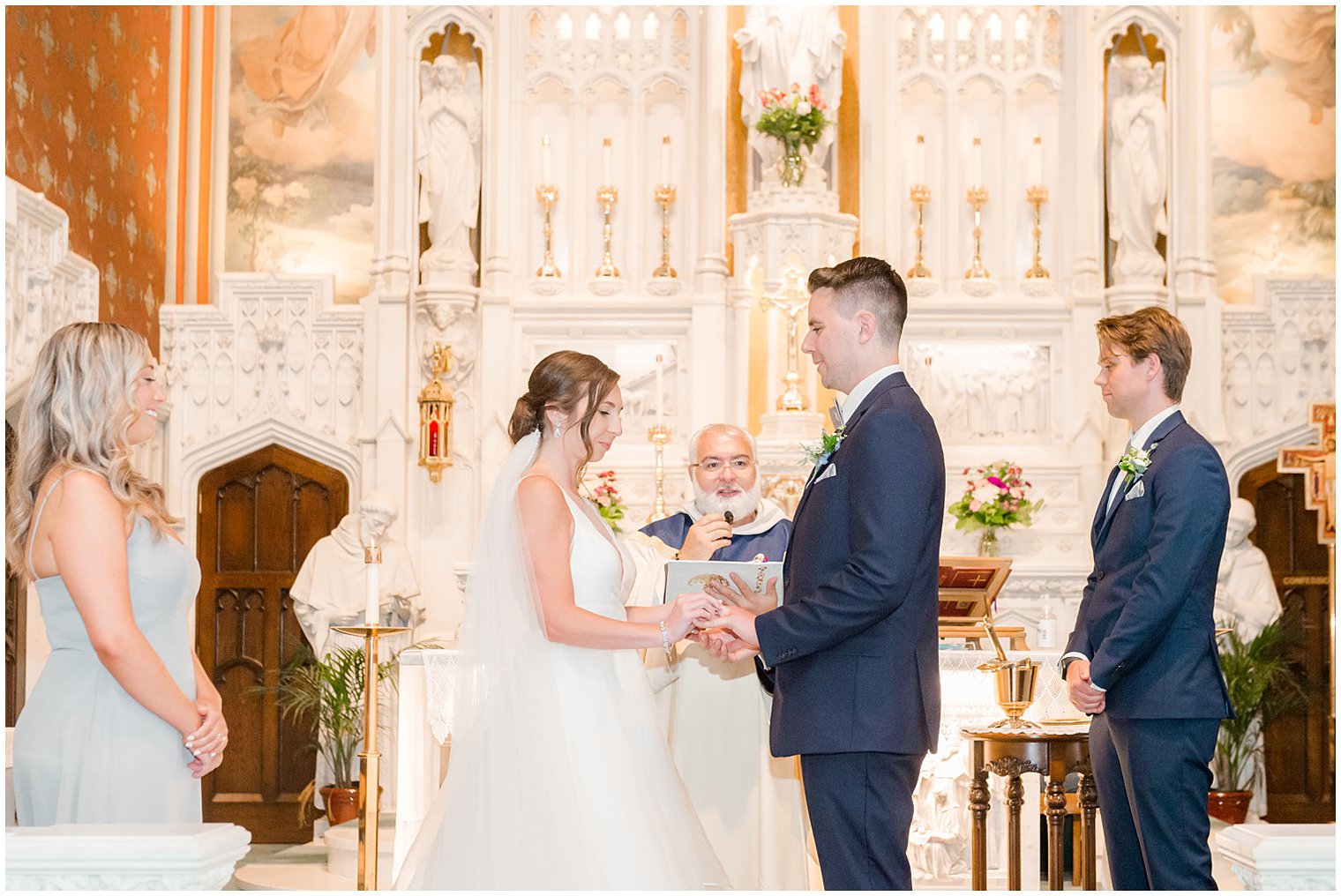 bride puts ring on groom during traditional church wedding in NJ