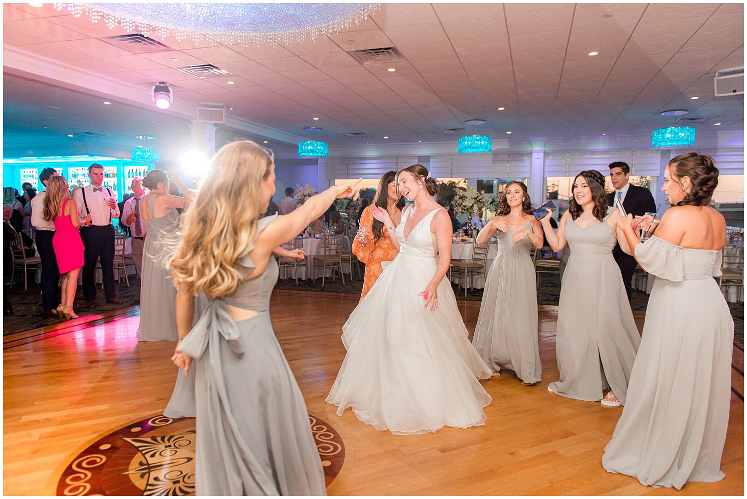 bride dances with bridesmaids during NJ wedding reception