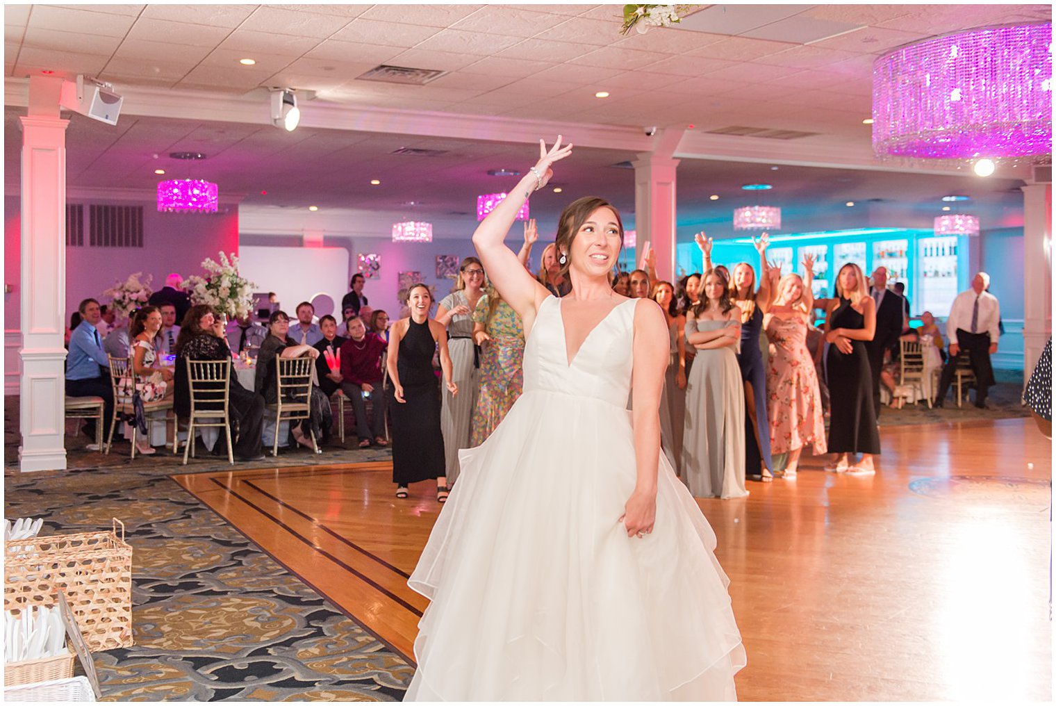 bride tosses bouquet during NJ wedding reception