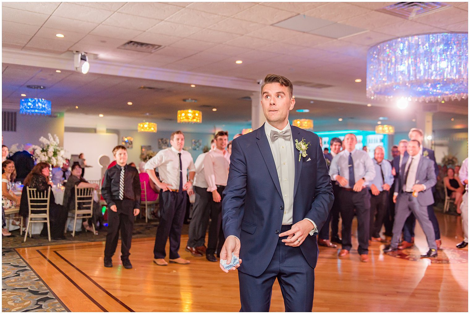 groom tosses garter during reception