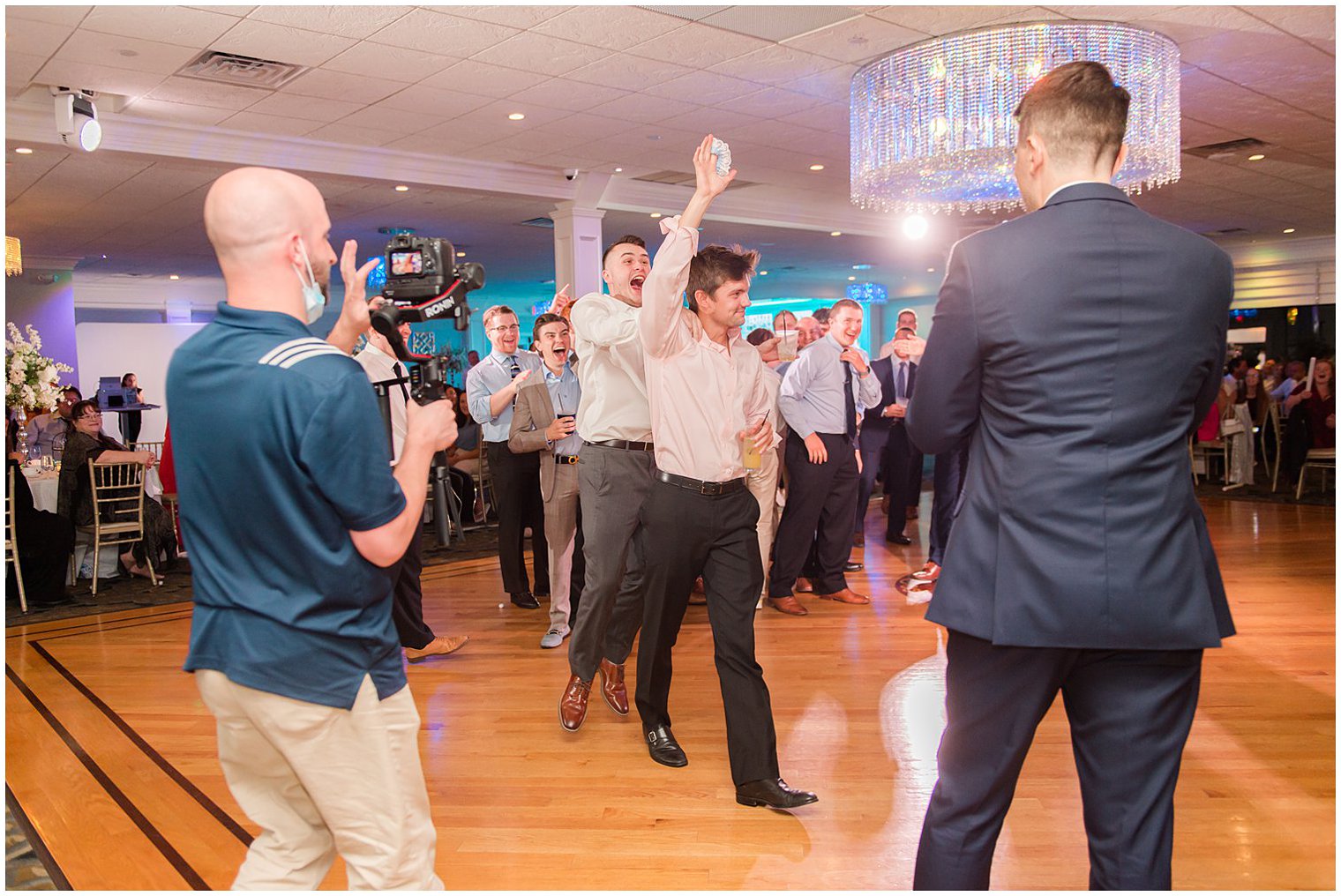 guest catches garter during NJ wedding reception