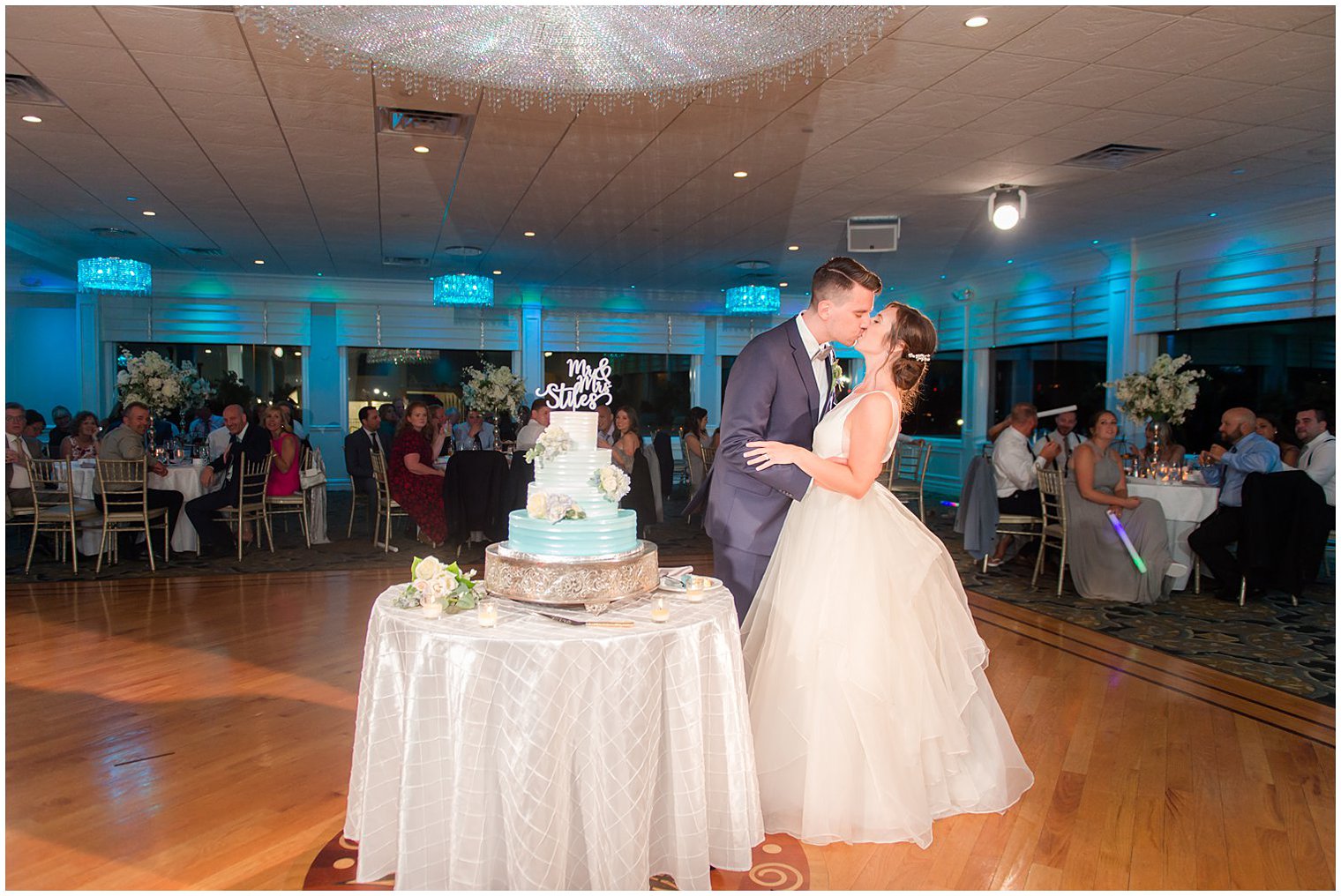 bride and groom kiss during cake cutting at NJ wedding reception
