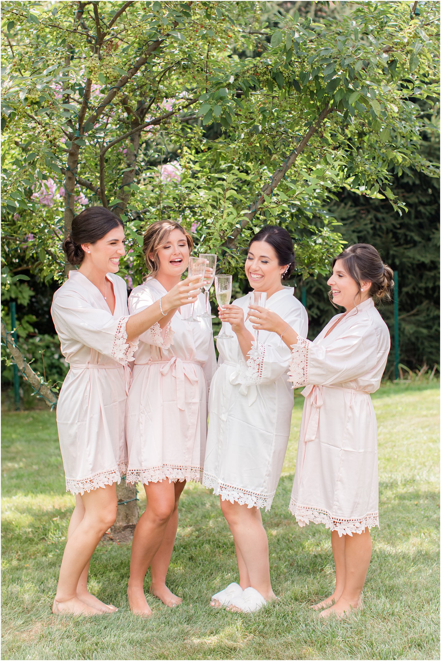 bride and bridesmaids toast champagne during wedding day prep