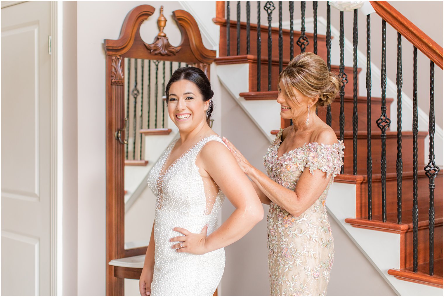 mom helps bride with wedding gown before NJ wedding
