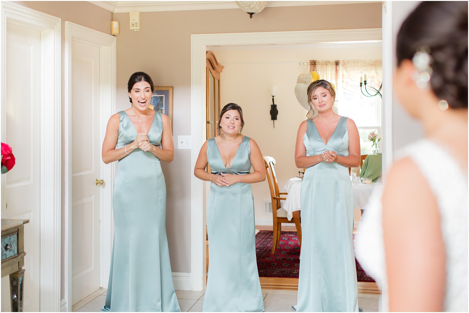 bridesmaids see bride in dress during first look