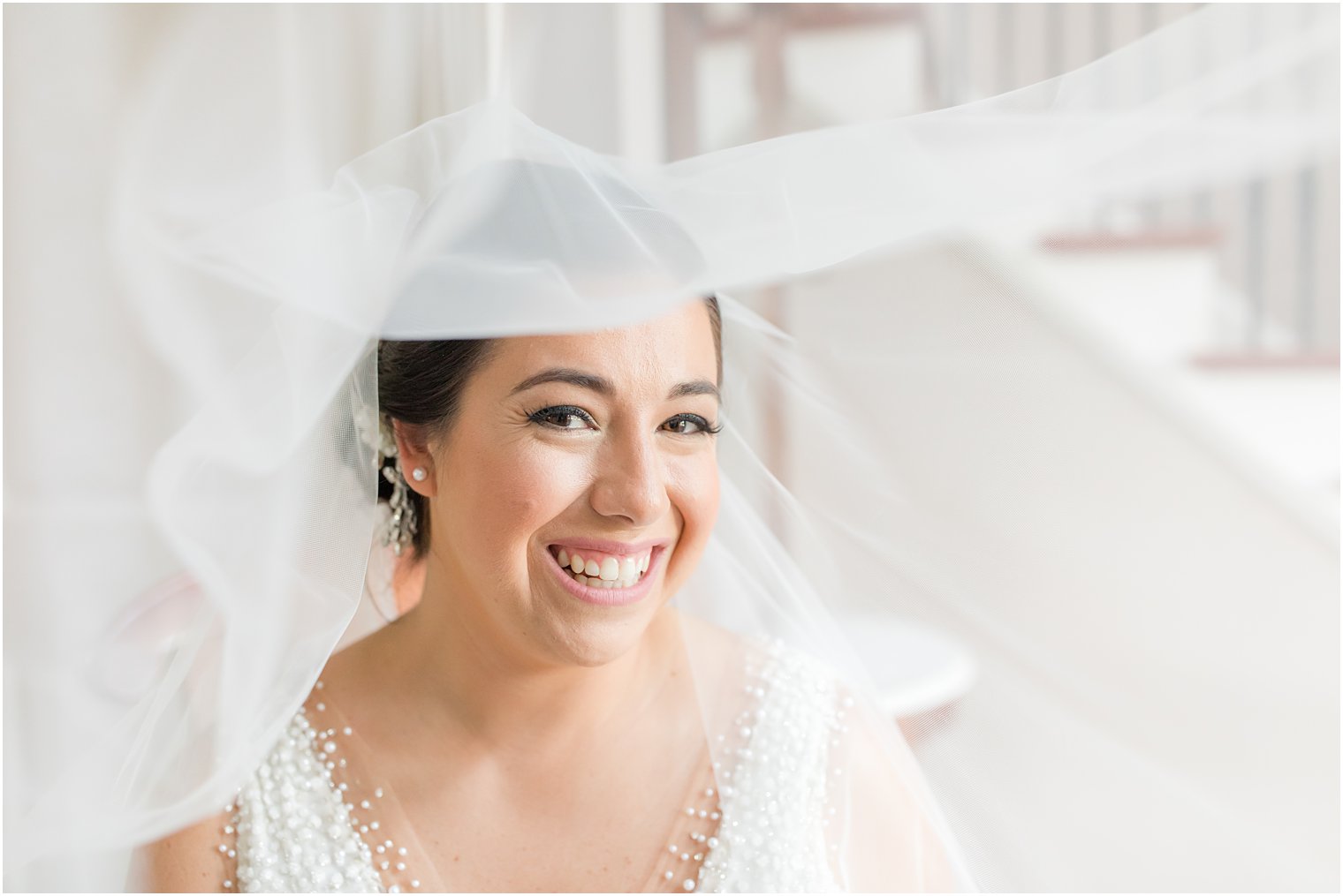 wedding portrait of bride from under veil