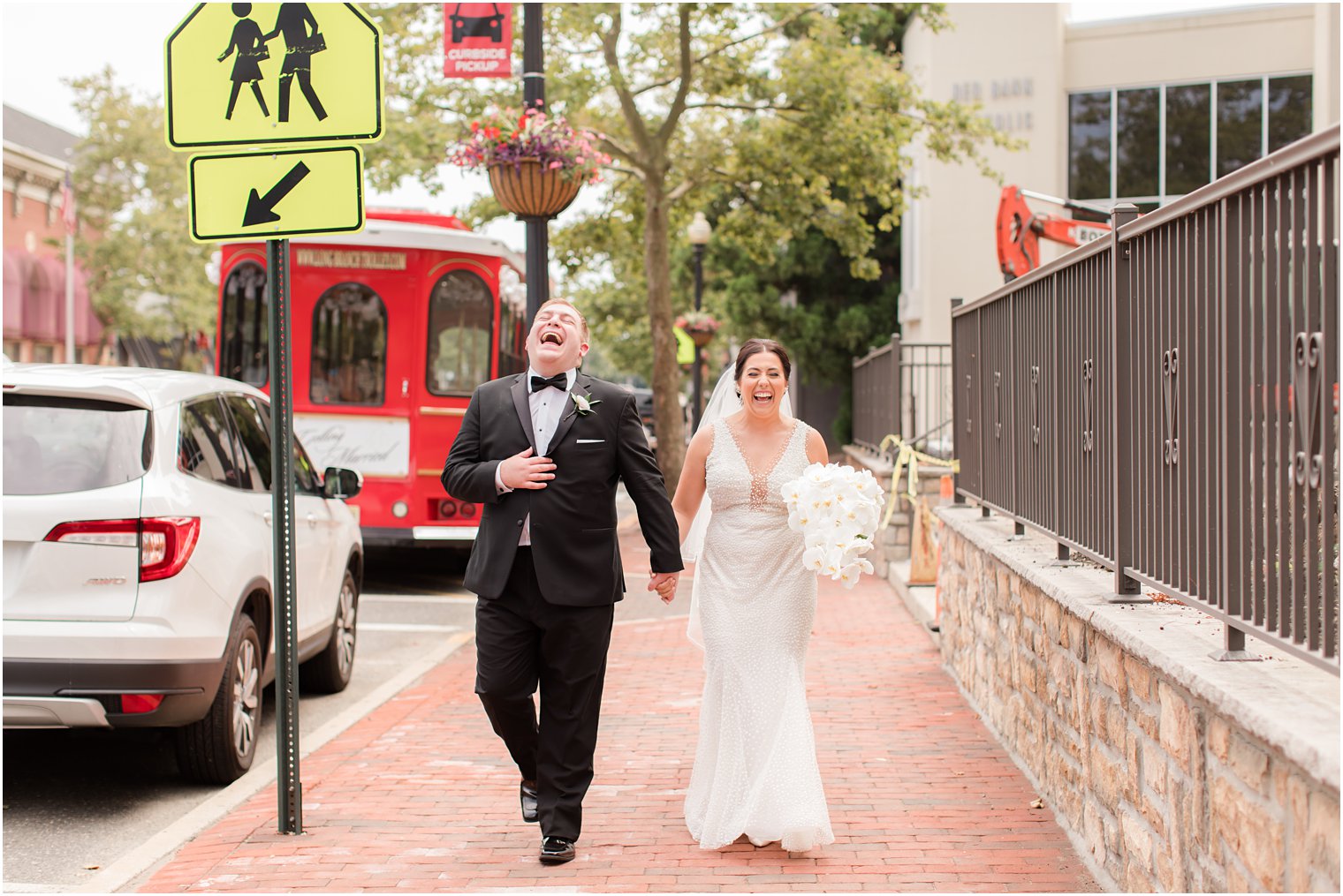 bride laughs walking with brother during wedding day