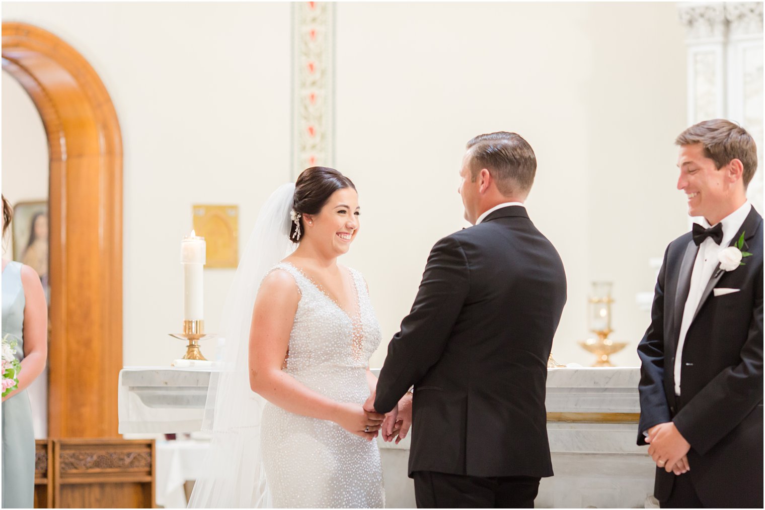 couple exchanges vows in traditional wedding ceremony at St. James church