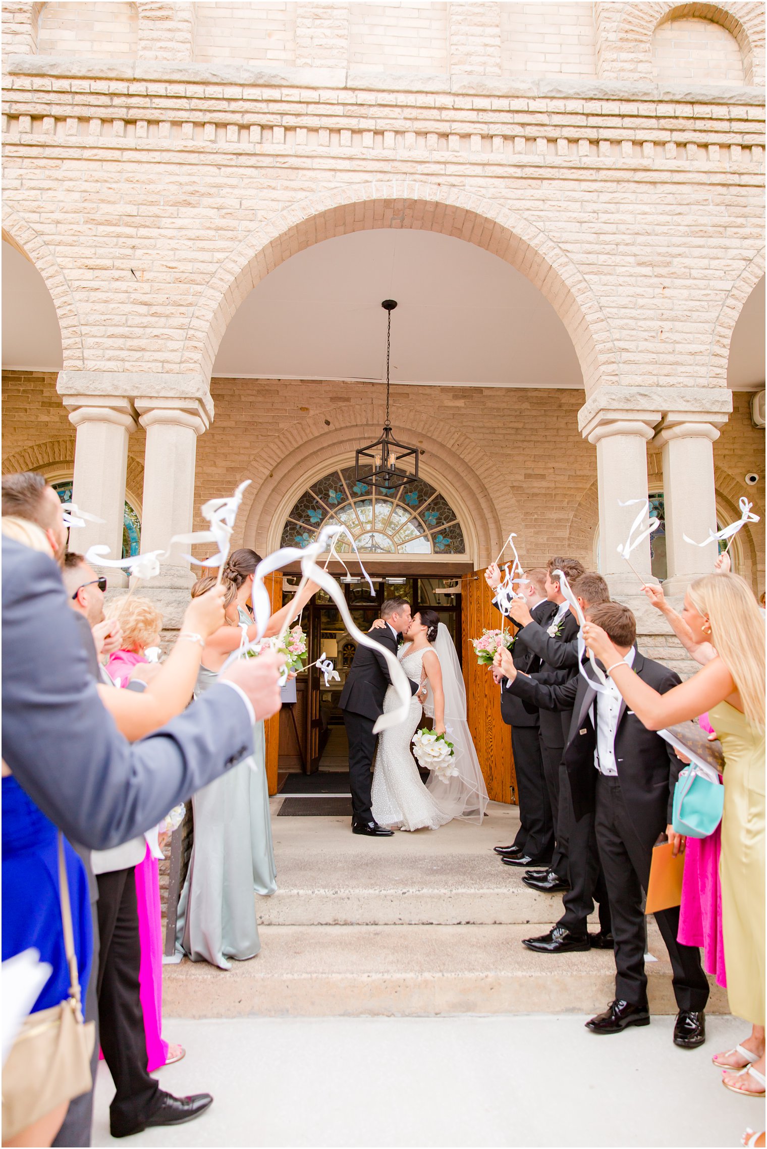 bride and groom kiss at church