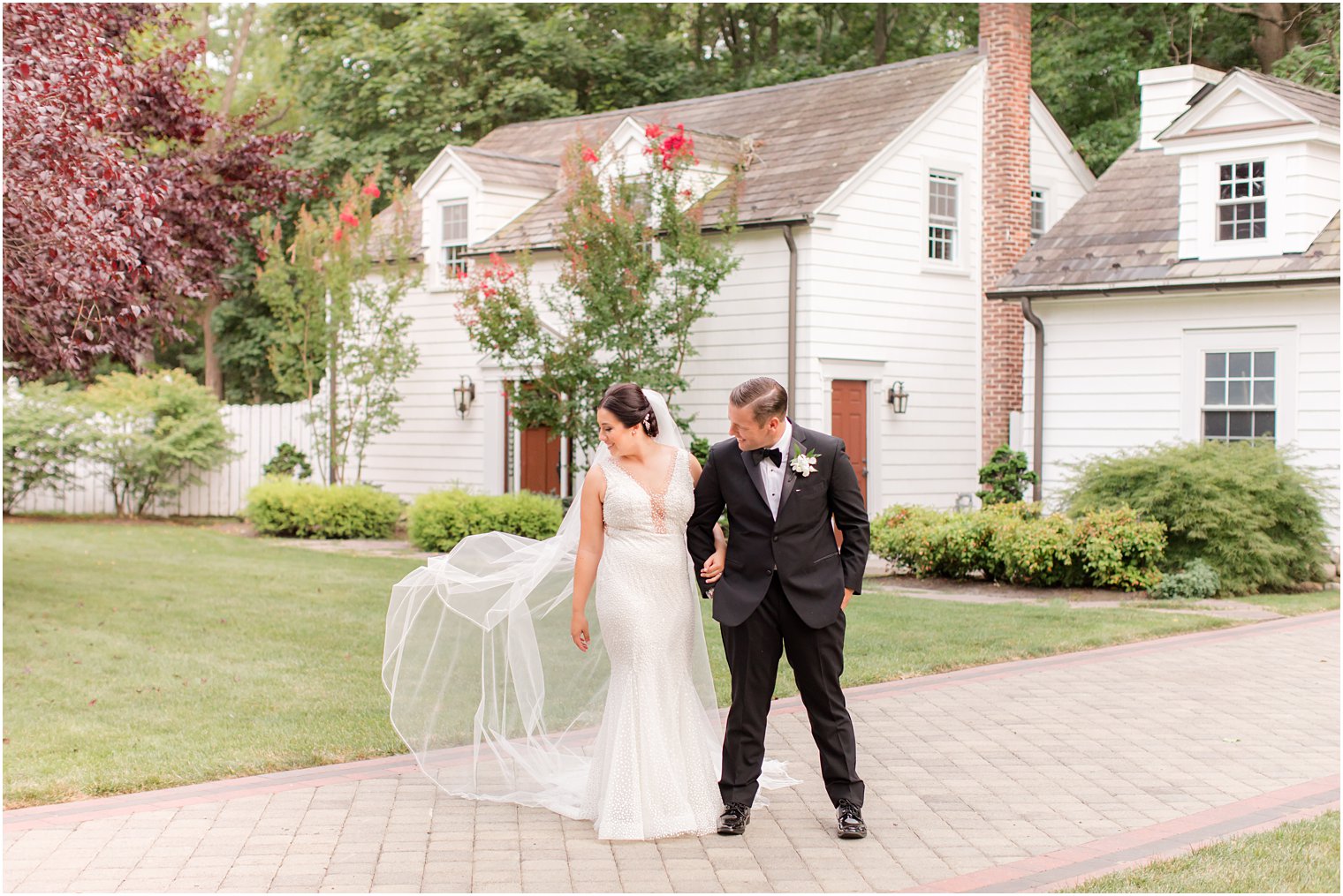 bride tosses veil behind her during NJ wedding photos 