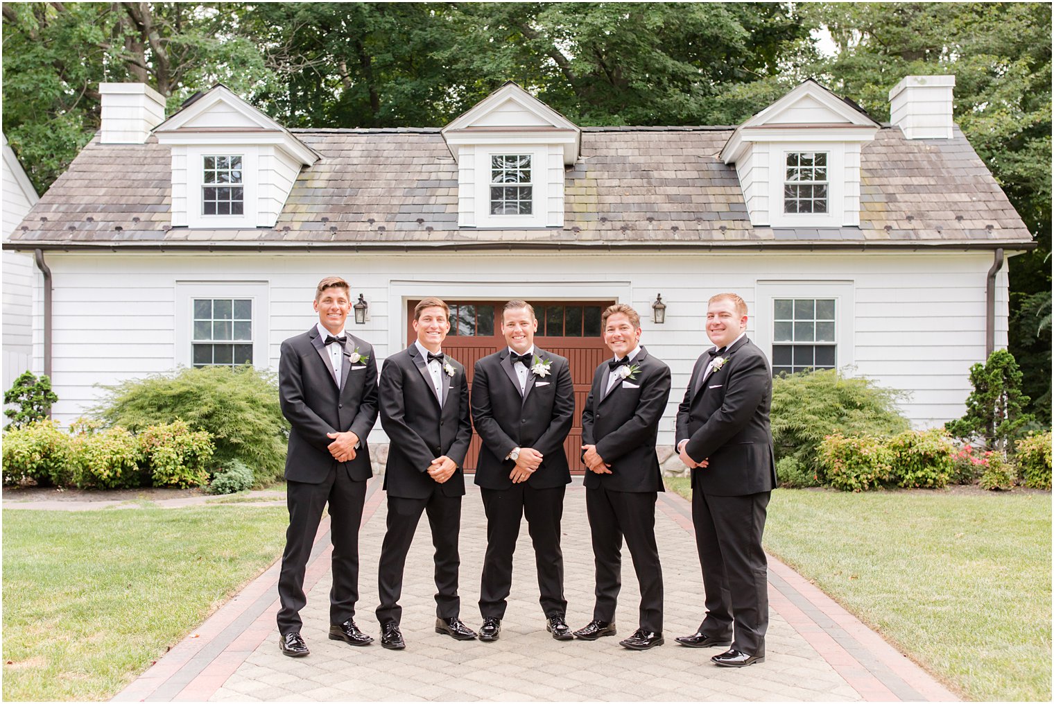 groom and four groomsmen pose with hands crossed in New Jersey 