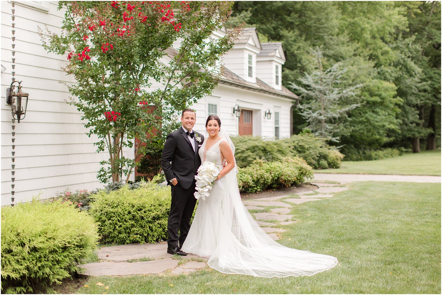 newlyweds photographed on lawn at The English Manor by Ocean Township NJ wedding photographer Idalia Photography