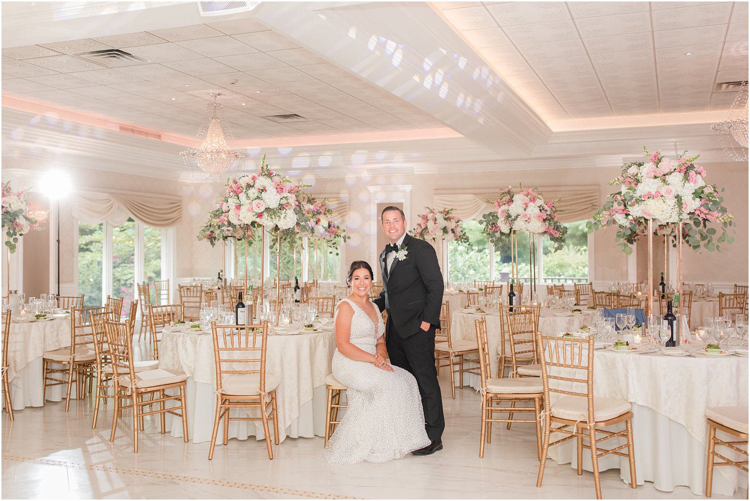 bride and groom pose in The English Manor reception space