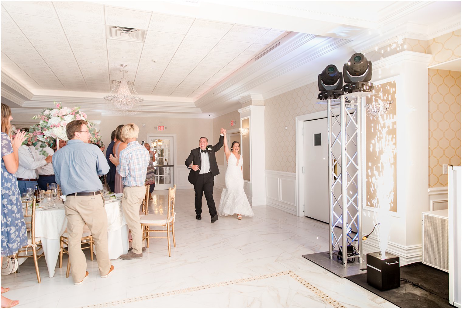 newlyweds enter wedding reception at The English Manor