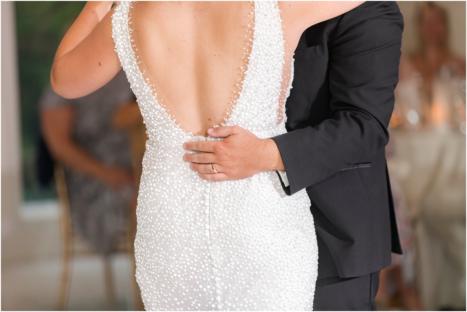 groom holds bride's hip during first dance in New Jersey 