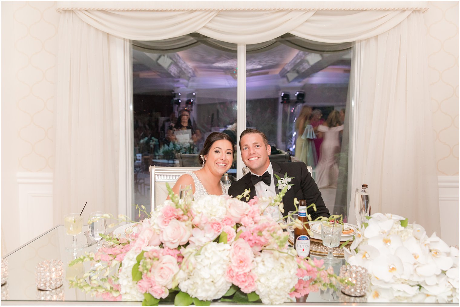 bride and groom smile at sweetheart table at The English Manor