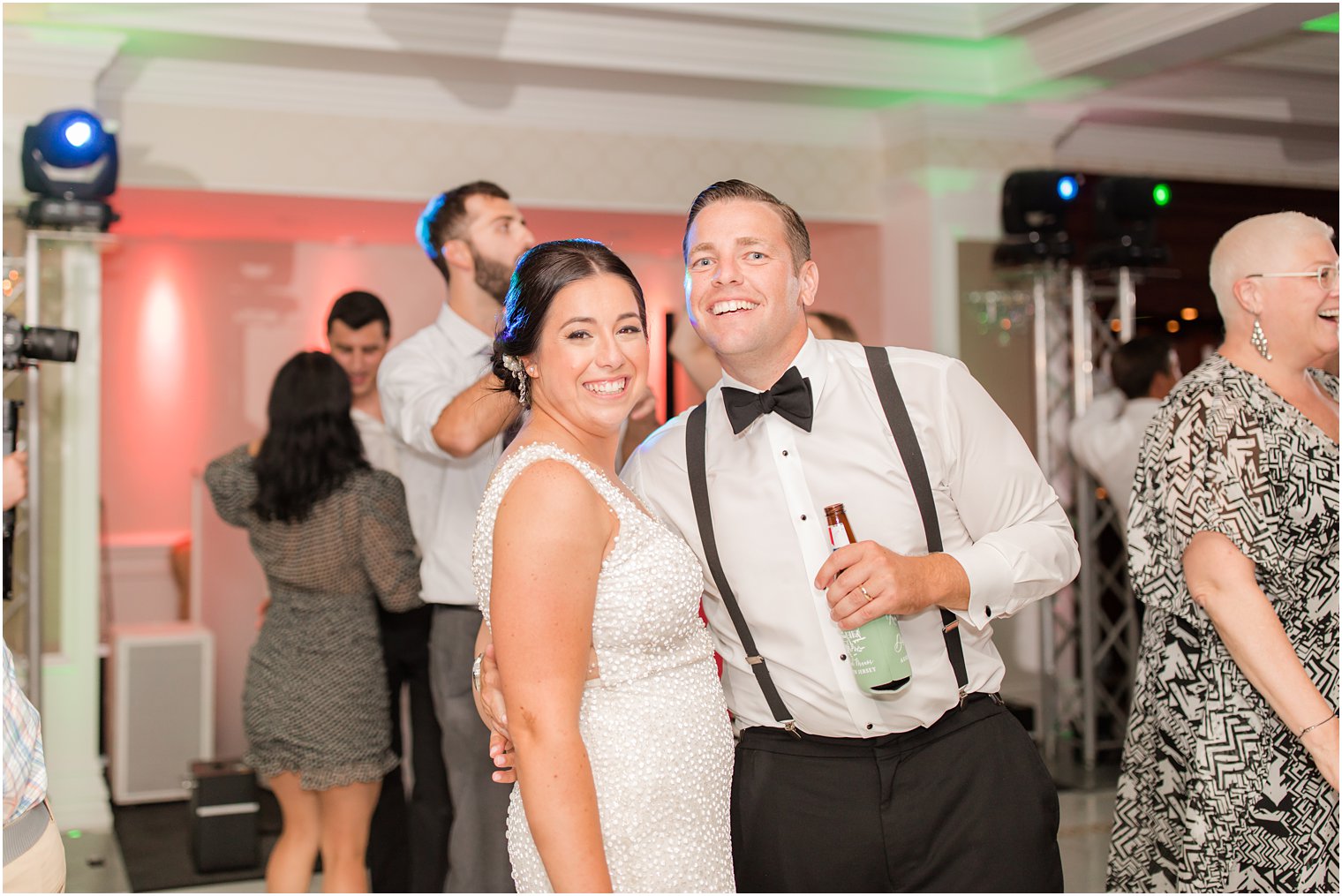 bride and groom smile during NJ wedding reception