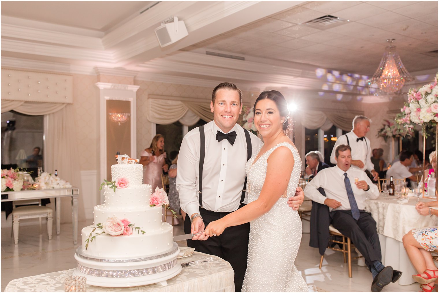 bride and groom cut wedding cake during NJ reception 