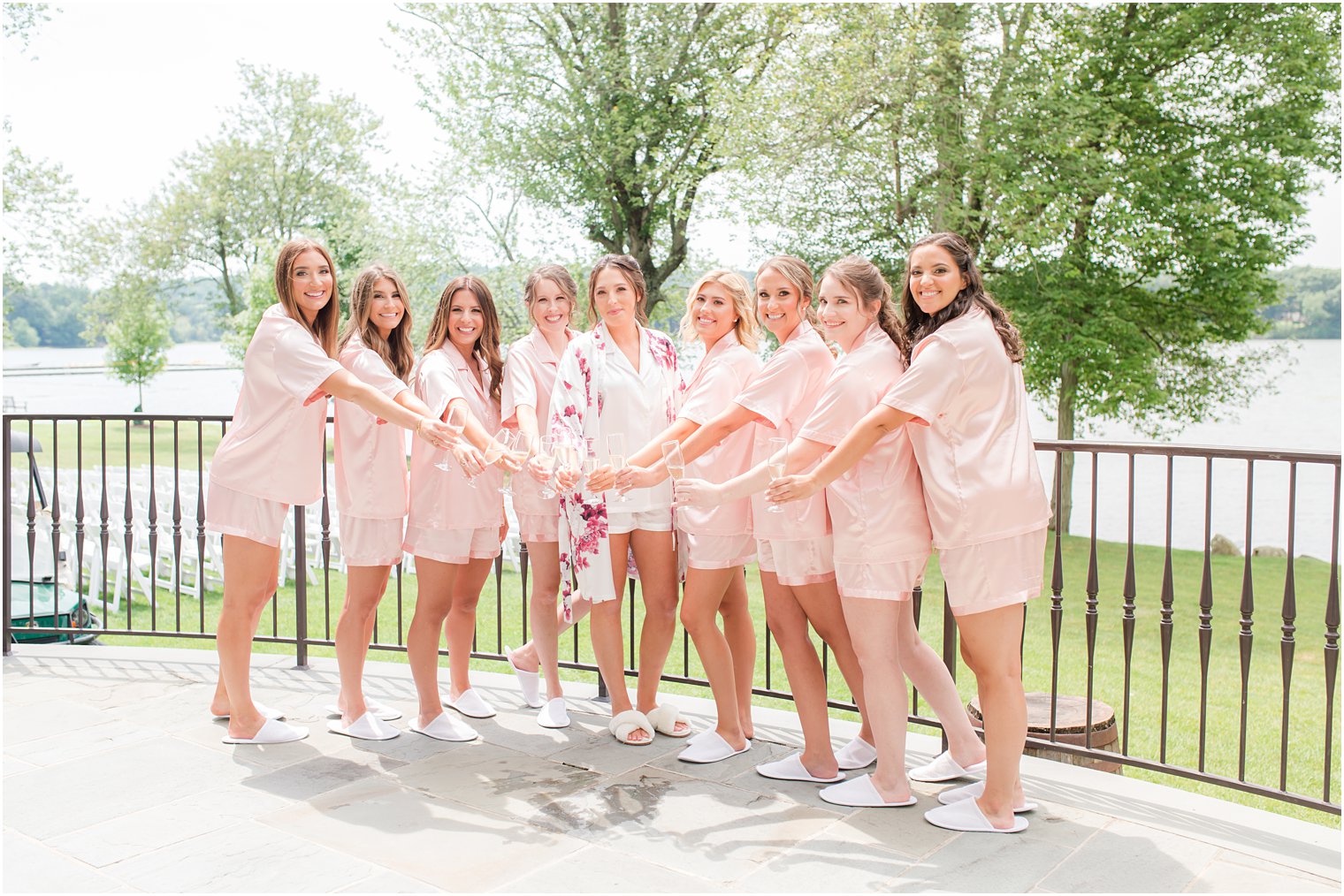 bride and bridesmaids hold champagne during NJ wedding prep