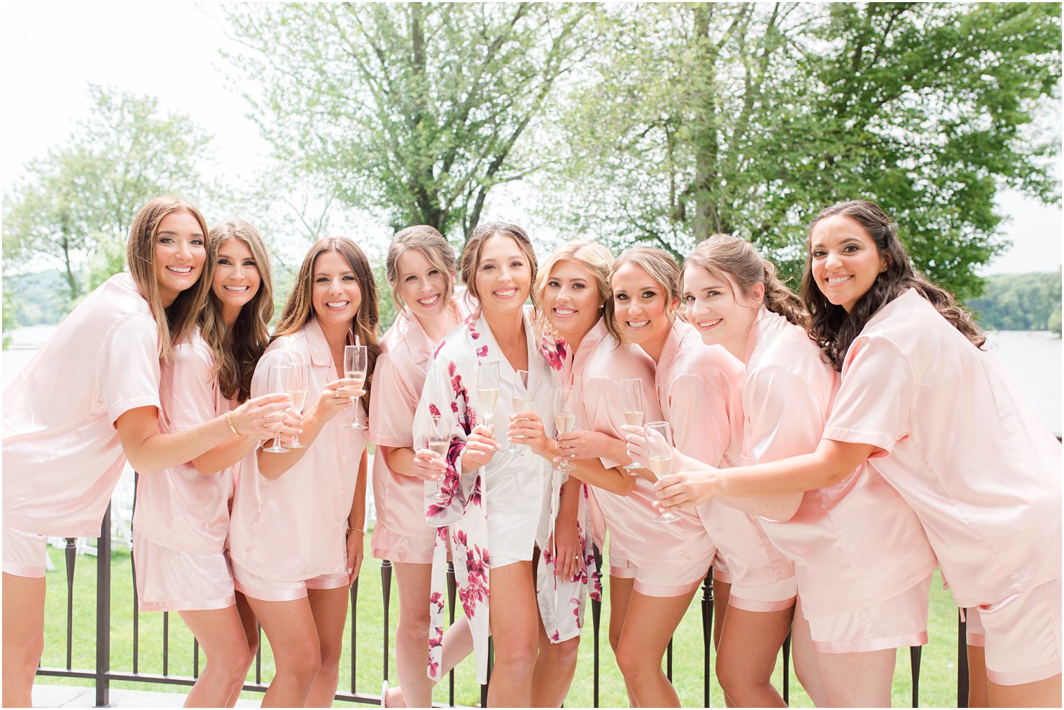 bride and bridesmaids toast champagne on patio at Indian Trail Club