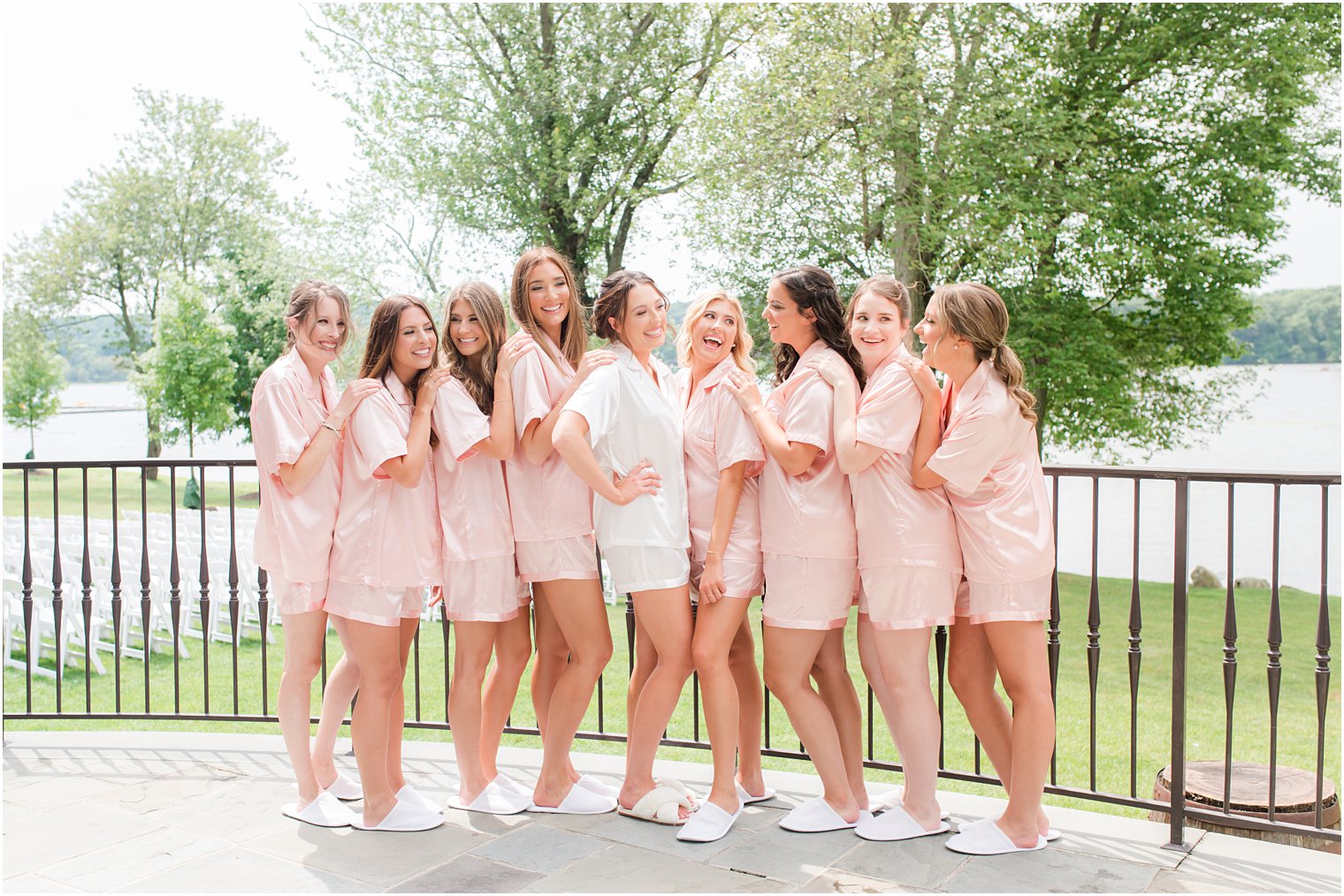 bride laughs with bridesmaids in pink pajamas
