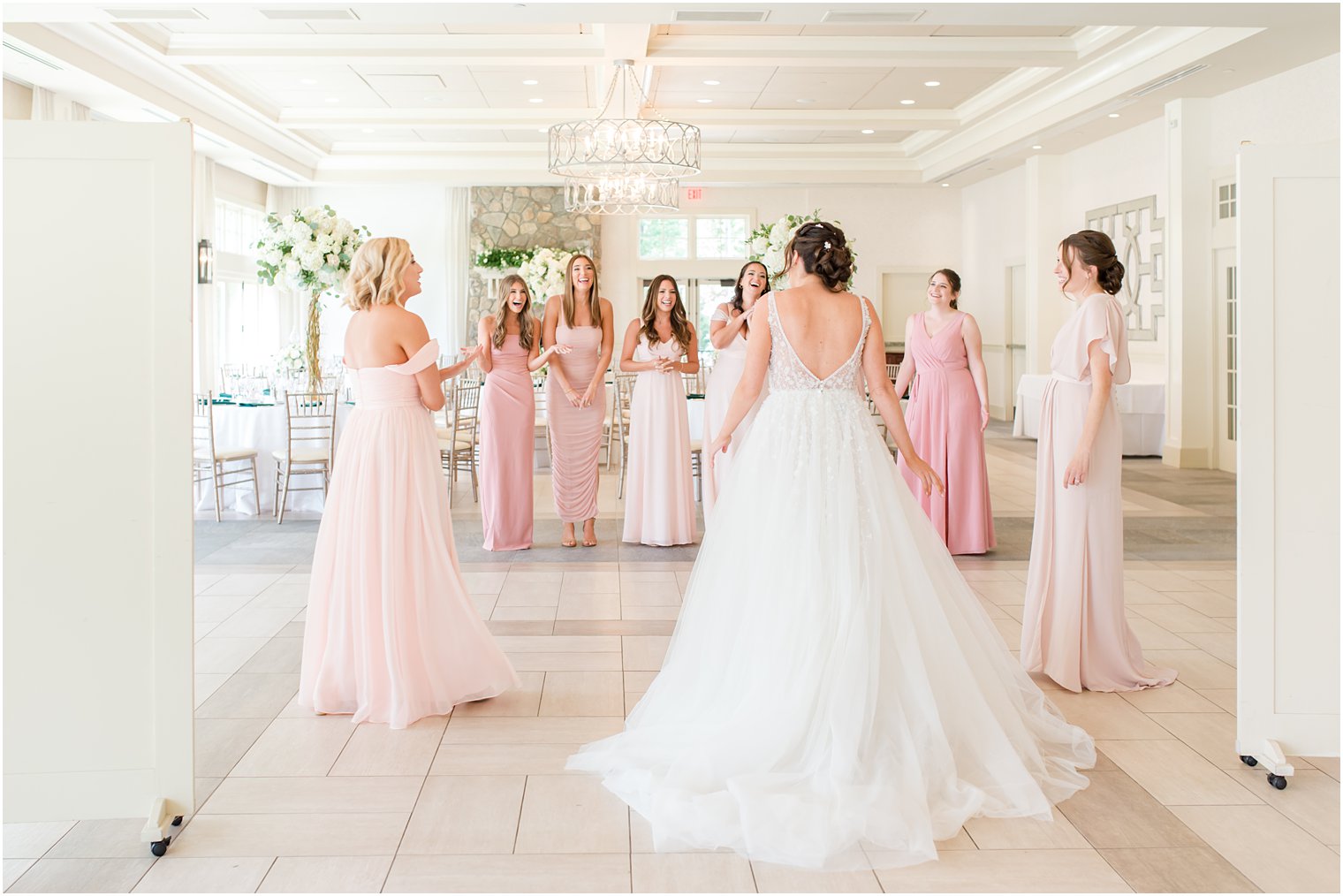 bride has first look with bridesmaids before Indian Trail Club wedding