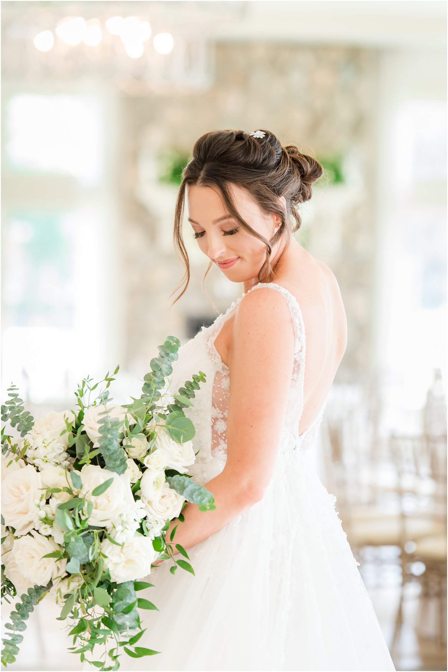 bride looks over shoulder holding bouquet in Franklin Lakes NJ