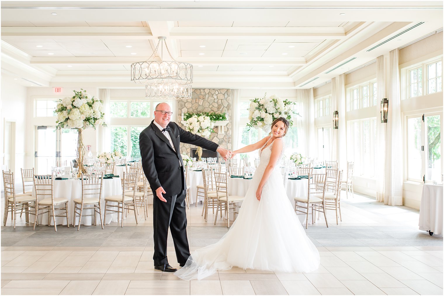 bride and dad pose in ballroom at Indian Trail Club