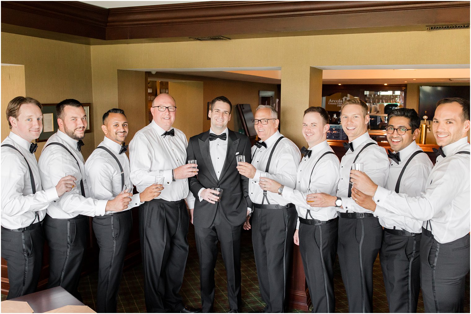 groom poses with dads and groomsmen at Indian Trail Club