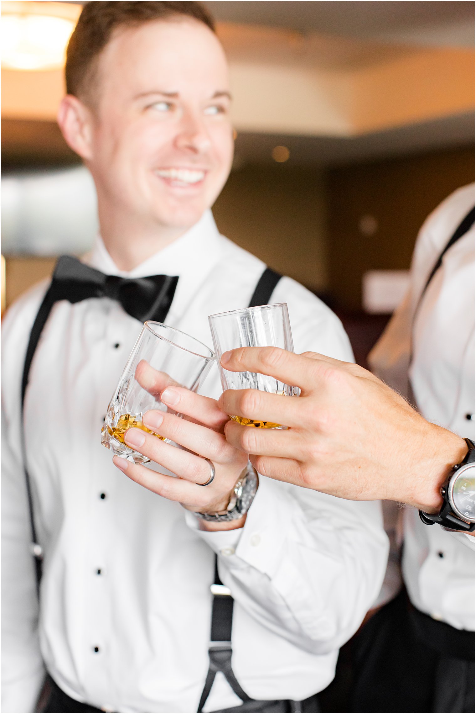 groom and groomsmen toast during wedding day prep