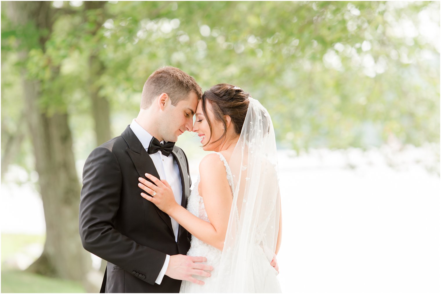 bride and groom pose with foreheads touching at Indian Trail Club