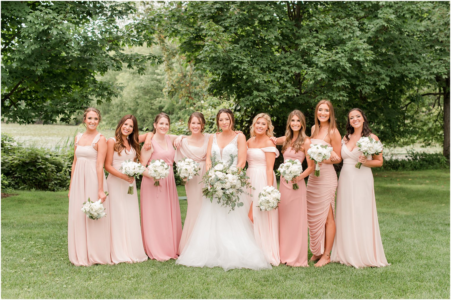 bride and bridesmaids in pink pose at Indian Trail Club