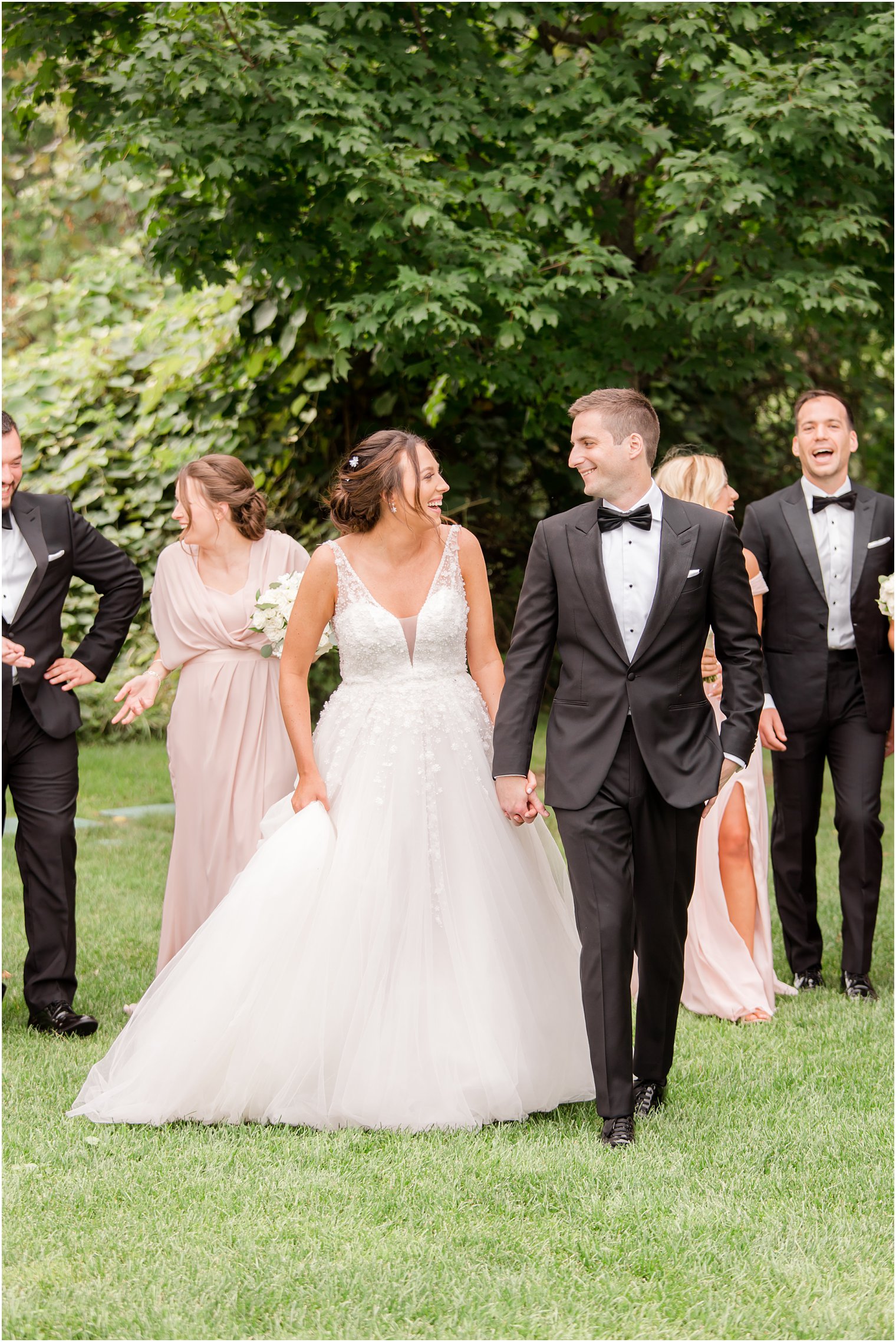 bride and groom walk with wedding party at Indian Trail Club