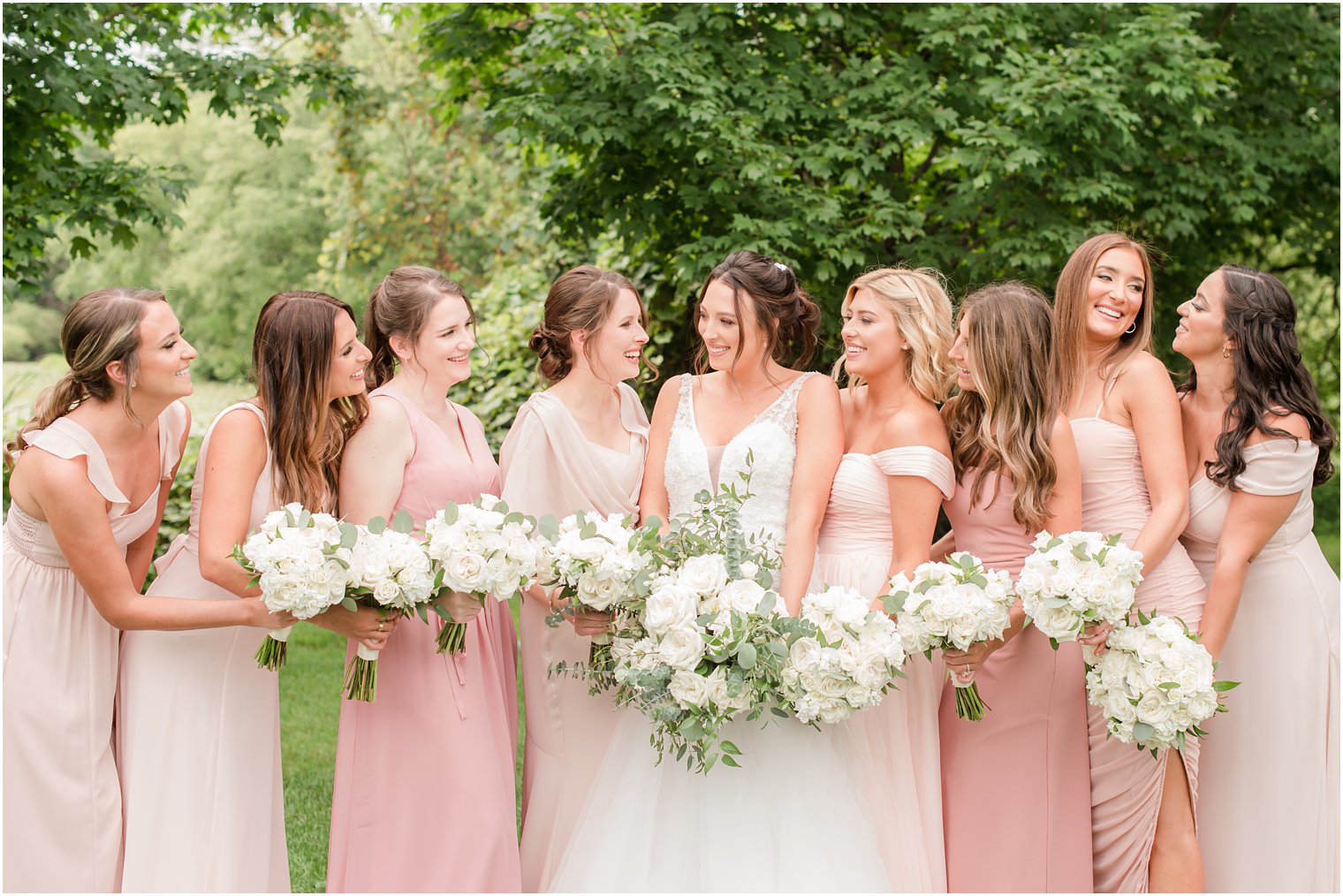 bride smiles with bridesmaids in New Jersey