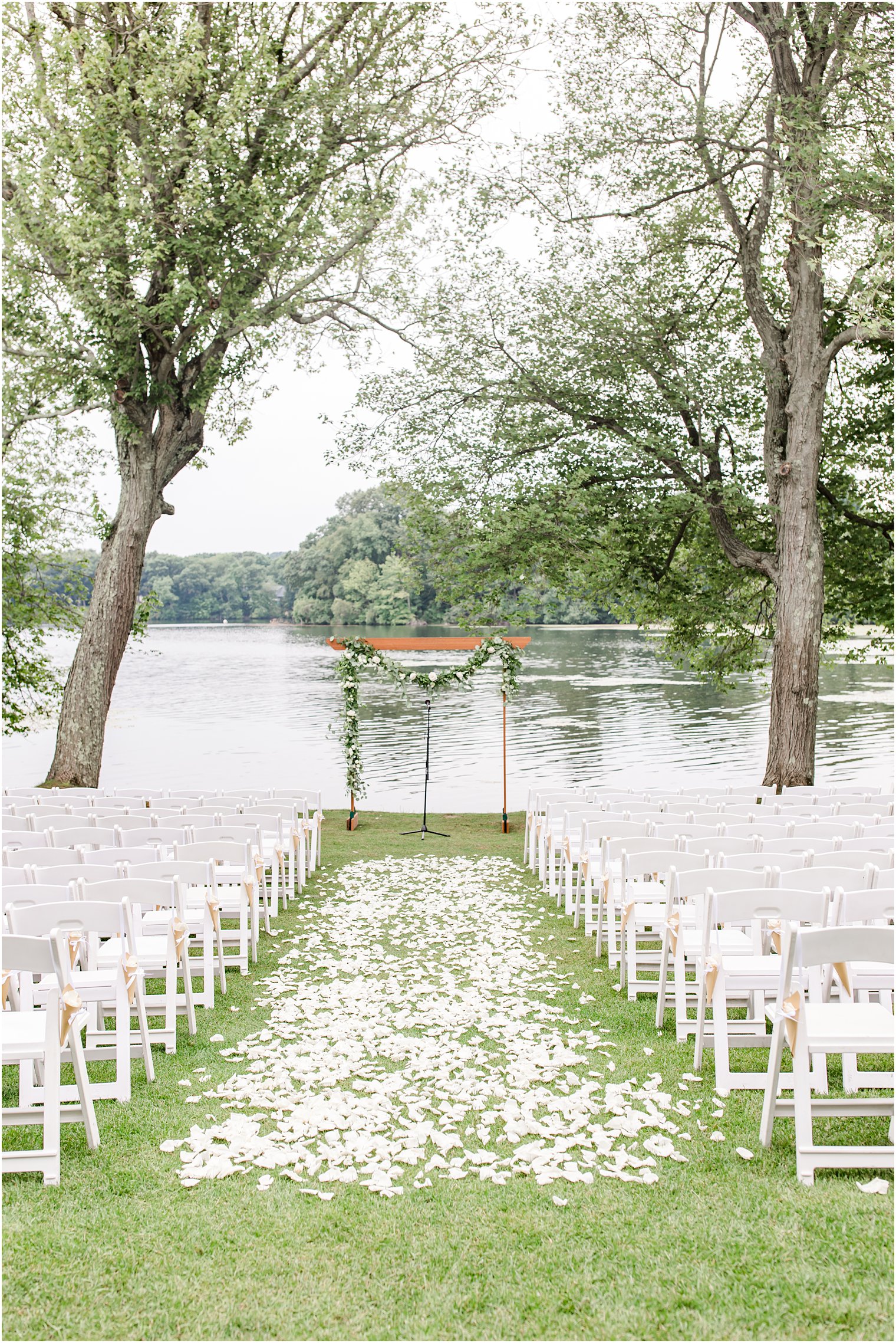 waterfront Indian Trail Club wedding ceremony with wooden arbor