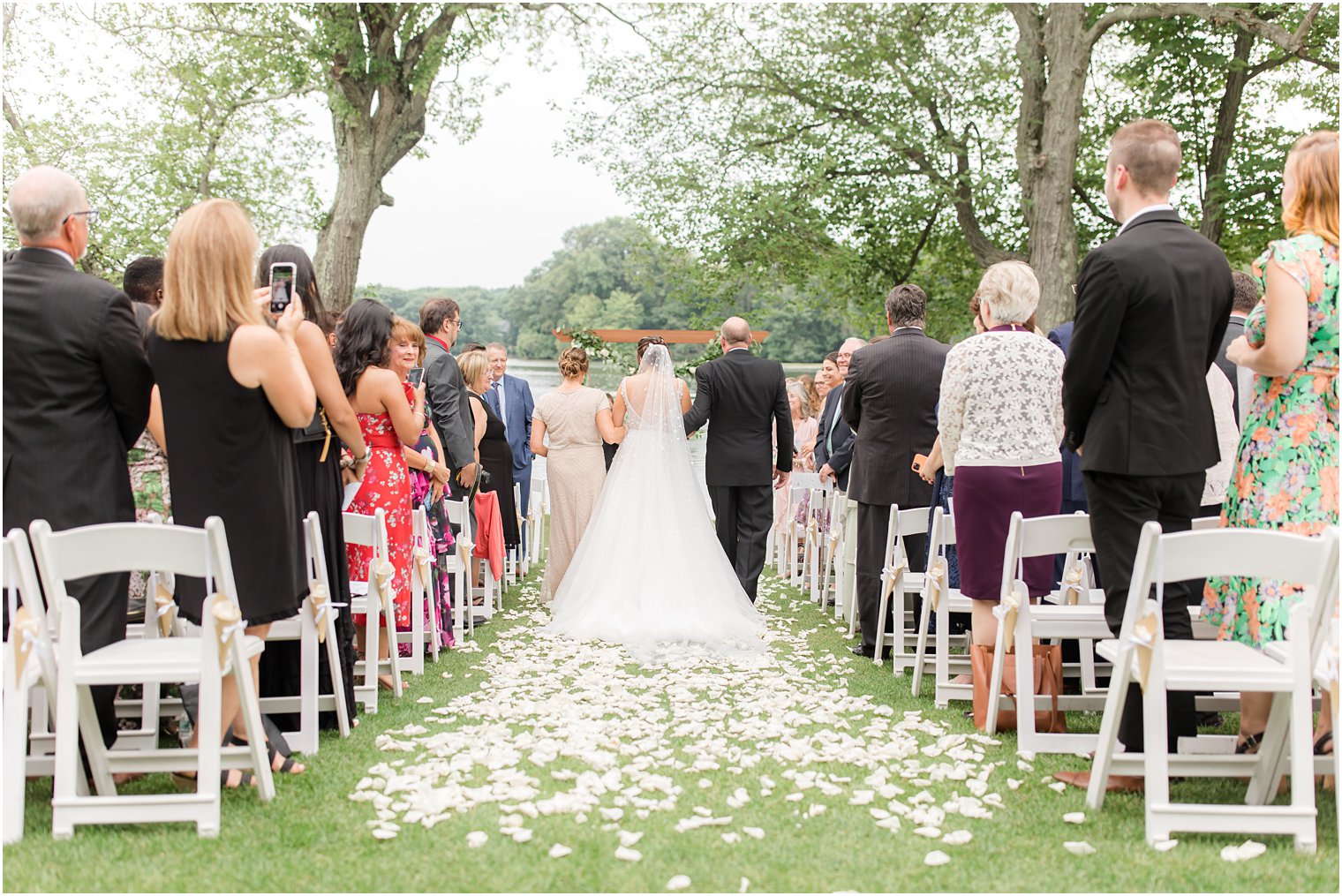 bride walks down aisle with parents at Indian Trail Club
