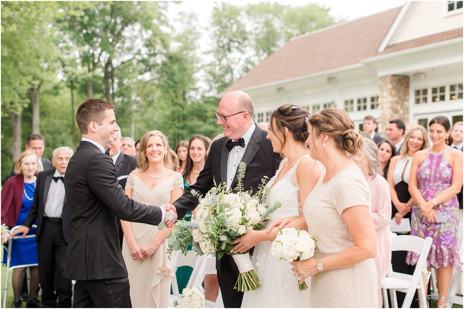 groom shakes dad's hand during NJ wedding ceremony