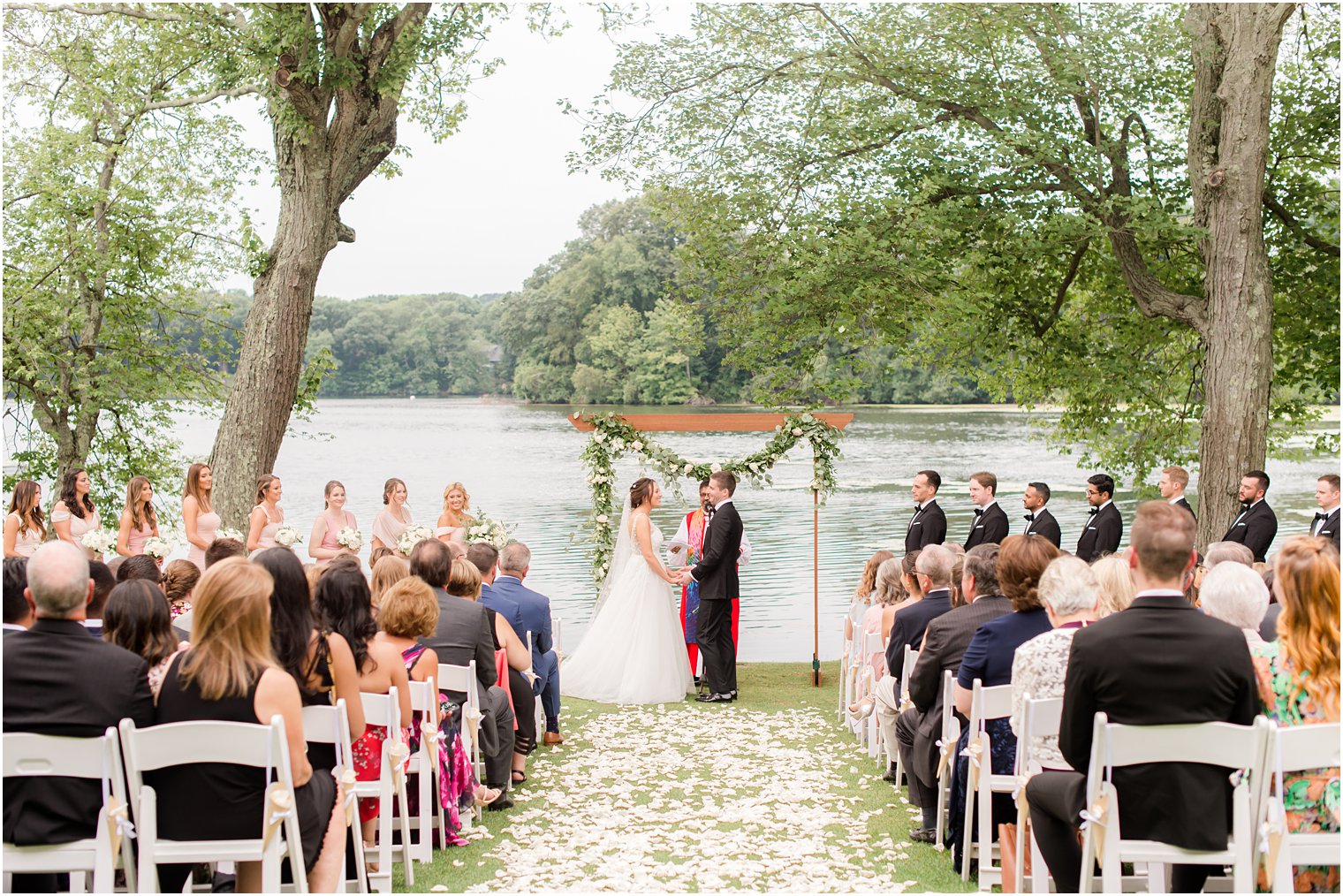 bride and groom exchange vows during waterfront wedding ceremony in Franklin Lakes NJ