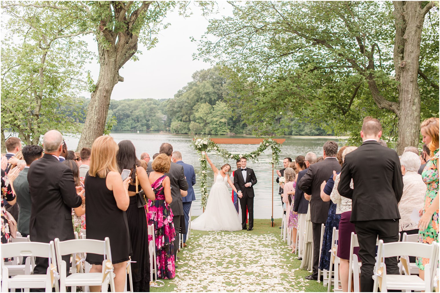 newlyweds cheer during waterfront wedding ceremony in Franklin Lakes NJ